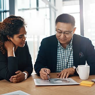 Franchise owners analyzing a report together.