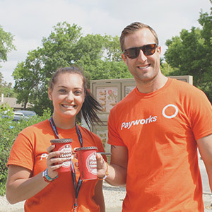 Payworks employees at a Tims Camps - Pay It Forward activity. Two Payworks employees participating in the Tims Camps community activity.