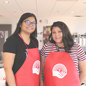 Payworks employees at a United Way - Pay It Forward activity. Two Payworks employees participating in an United Way community activity.