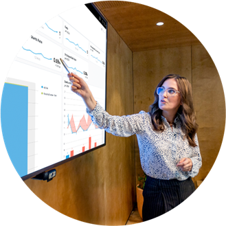 Woman presenting Payworks analytics in a big screen.