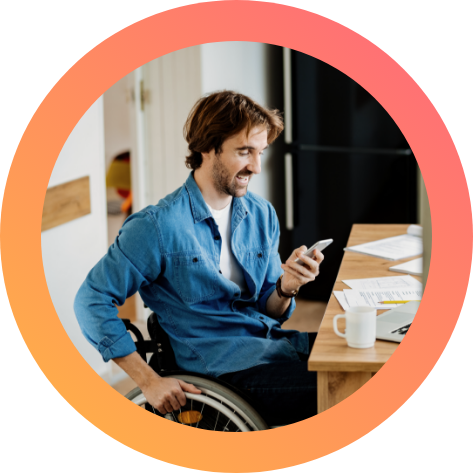 Worker looking a his mobile phone. Worker on wheelchair checking his mobile phone.