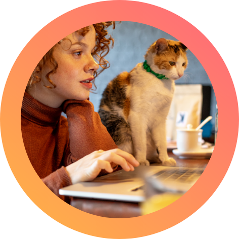 Woman working with cat Woman working on a laptop accompanied by a cat.
